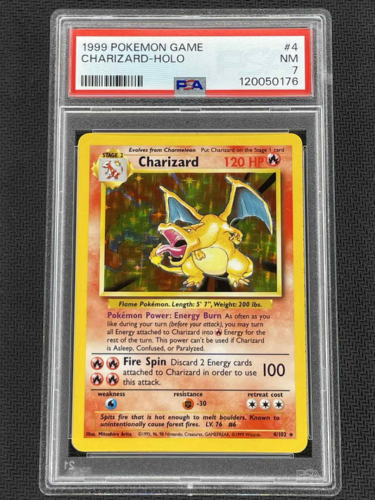 1999 Charizard holographic trading card in a protective case with PSA grading label.