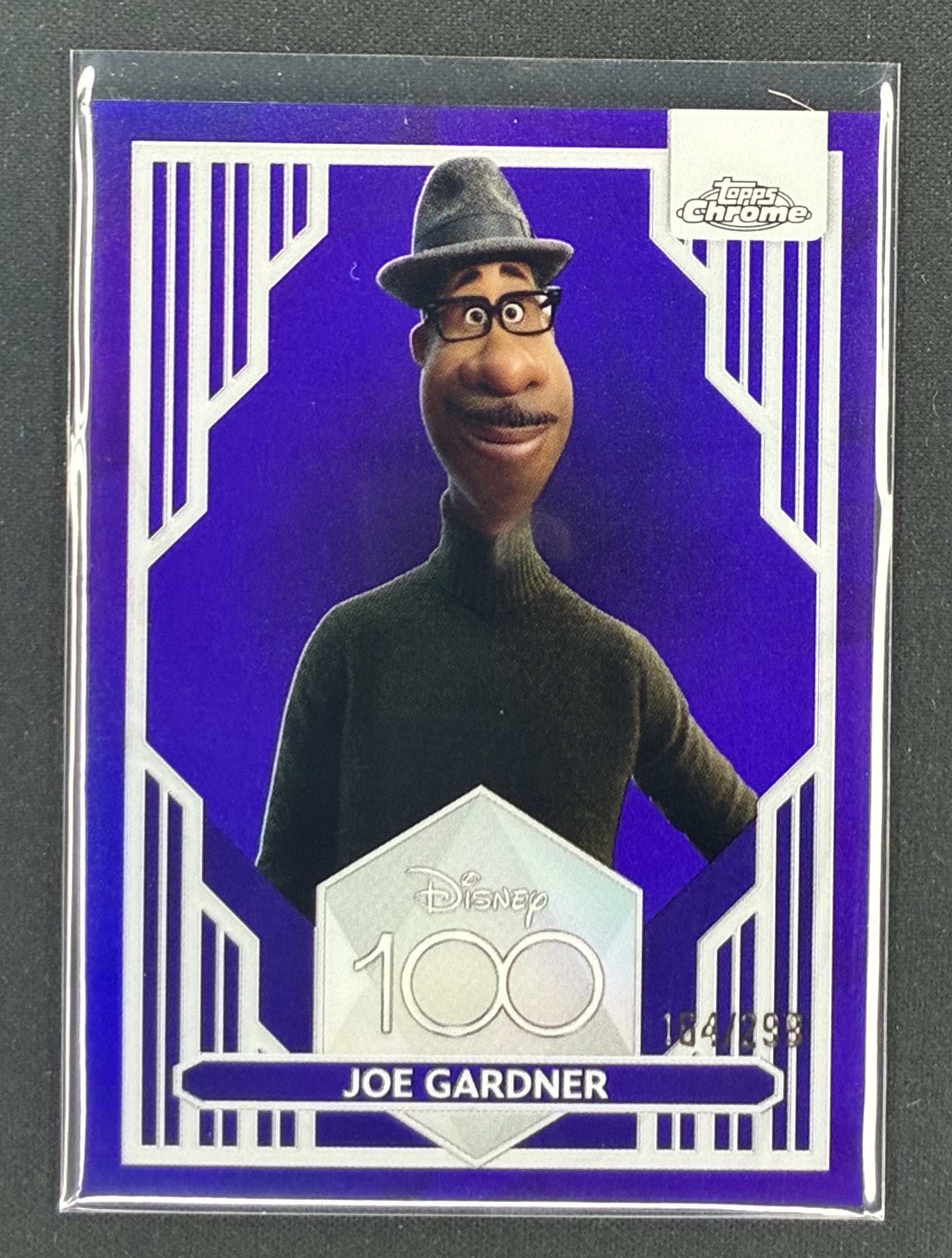 2023 Topps Chrome Disney 100 Joe Gardner number 64 Purple Refractor serial numbered to 299.