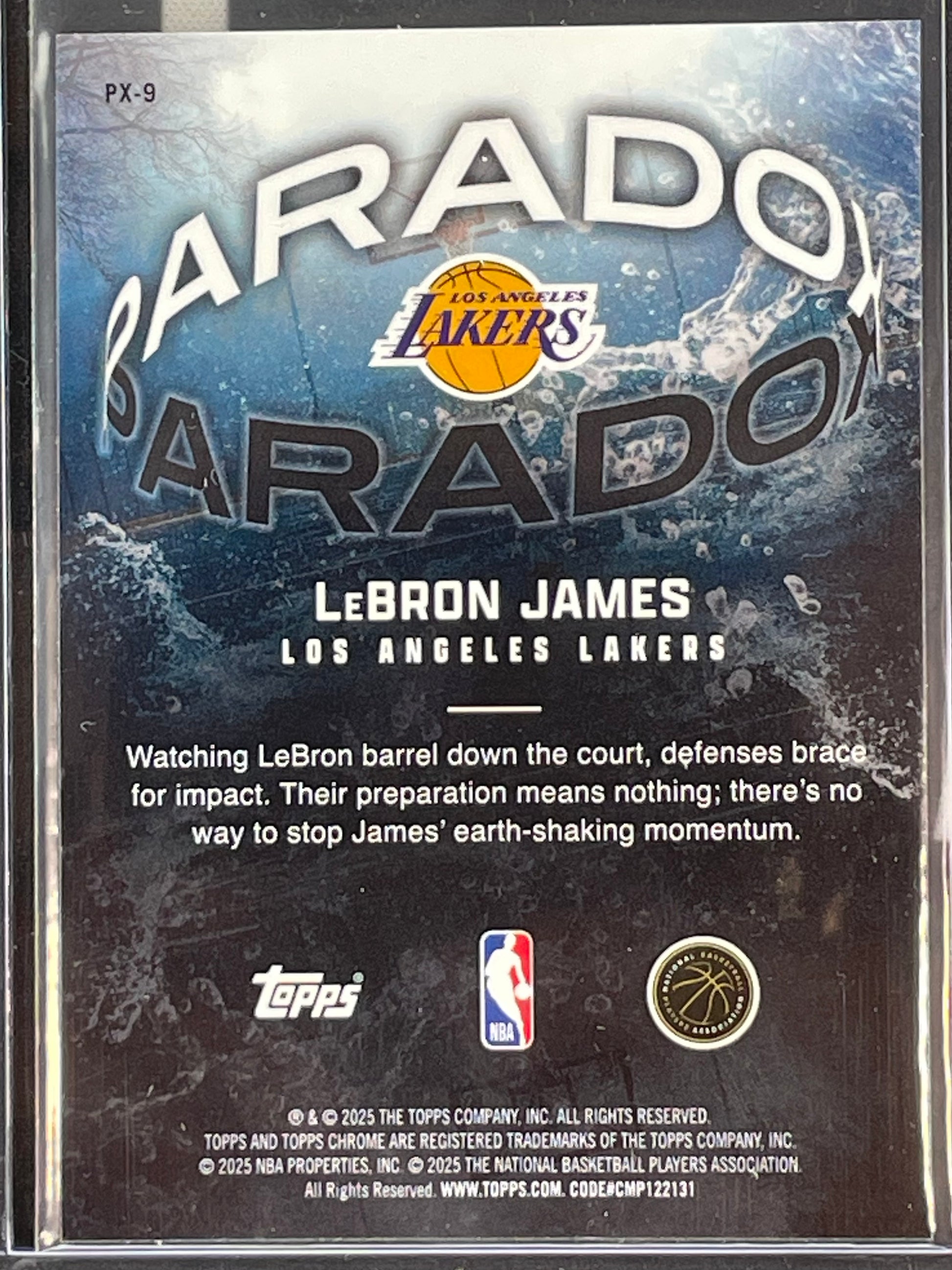 A collectible 2025 Topps LeBron James trading card inside a clear plastic protective sleeve, showing the back of the card with the Los Angeles Lakers logo, 'Barado' text, and a description of LeBron James.